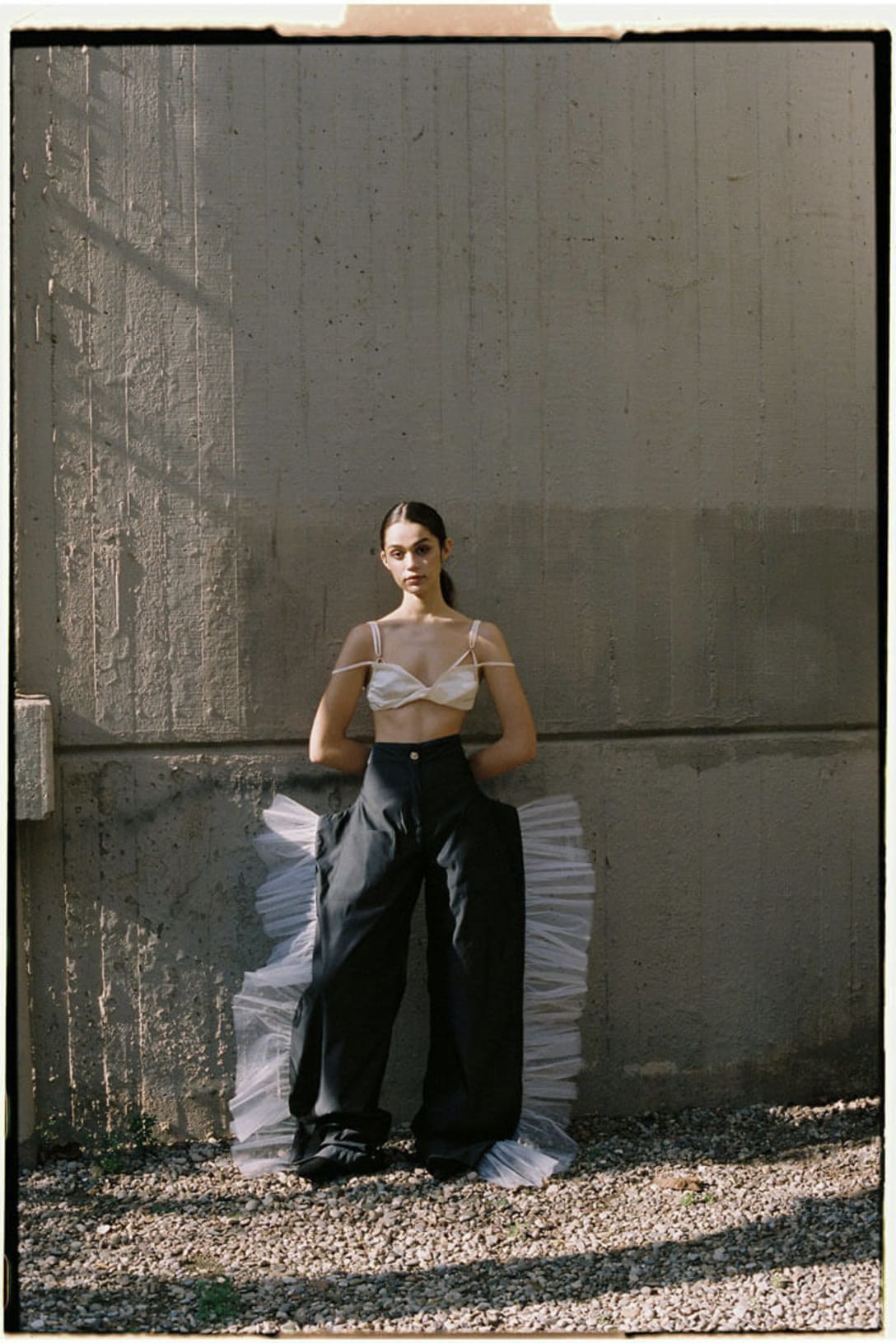 top by JACQUEMUS, trousers by PETER SPOSITO STUDIO